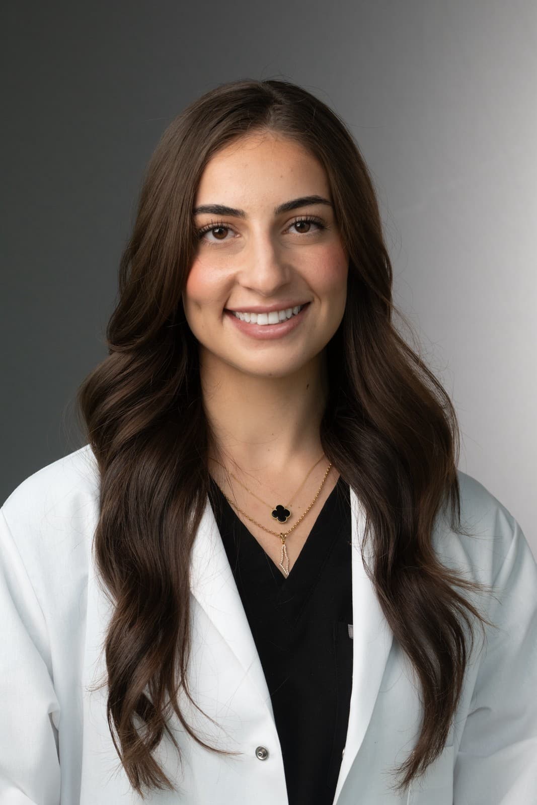 Professional headshot of Dr. Dana Hamdan in her white coat