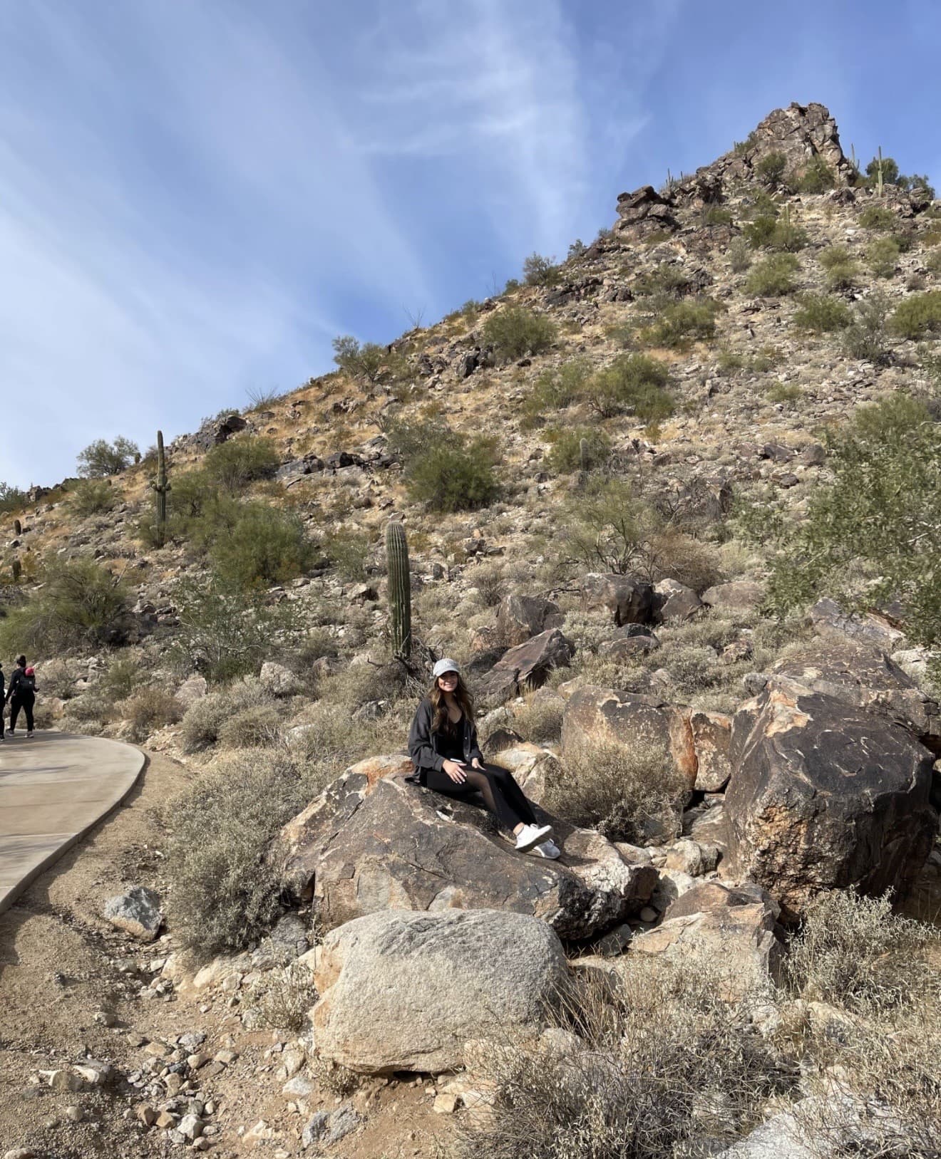 Dr. Dana Hamdan hiking on a desert trail