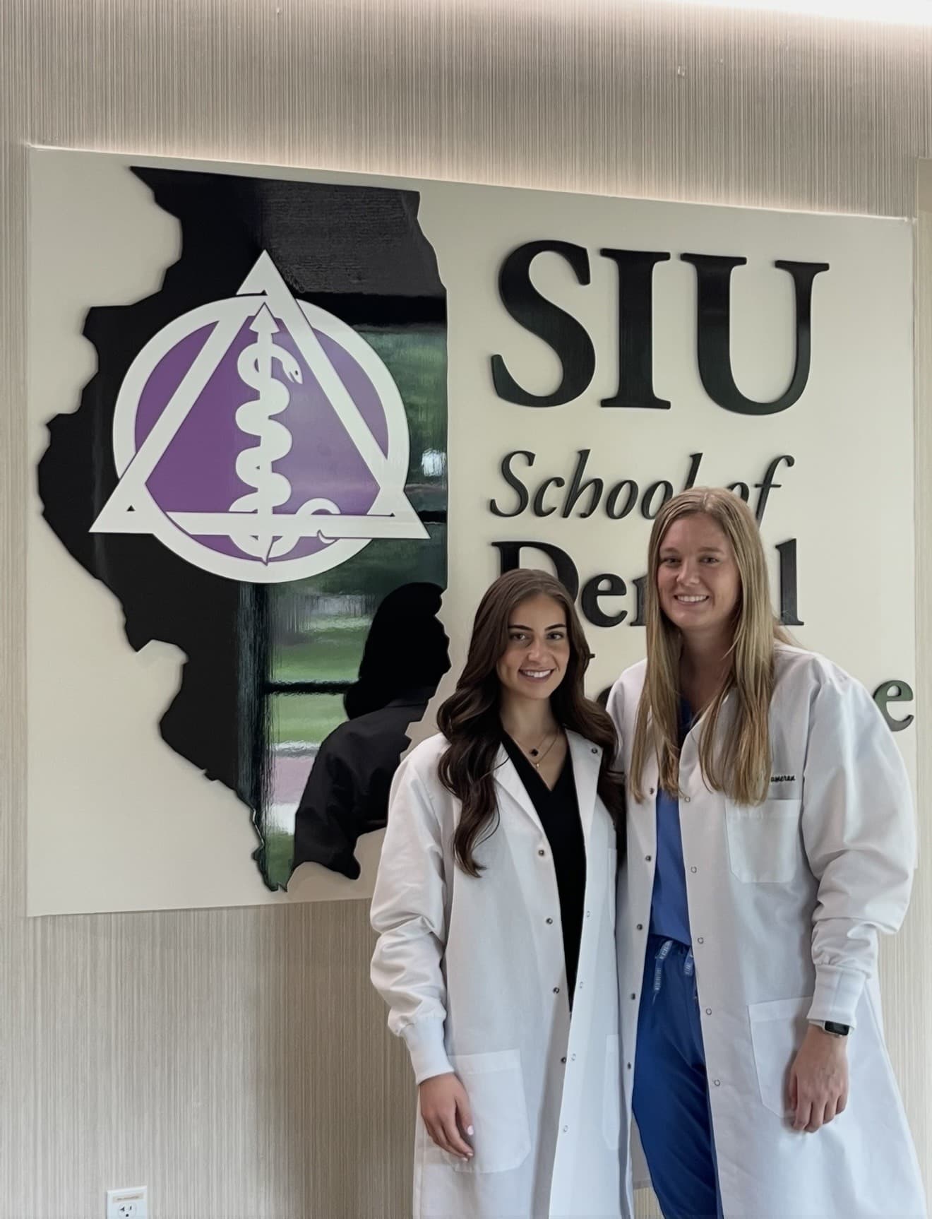 Dr. Dana Hamdan in her white coat at SIU School of Dental Medicine